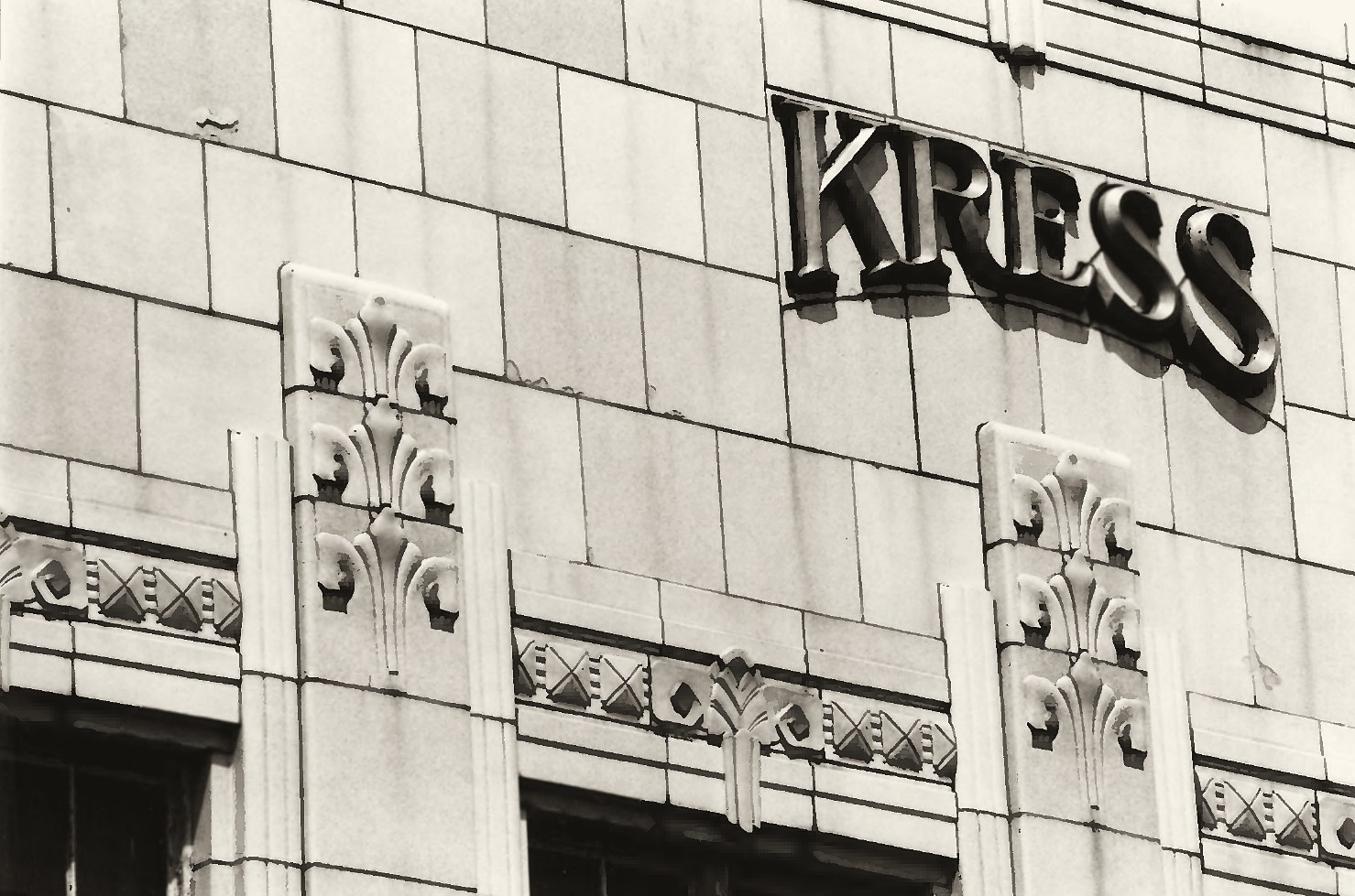 Close-up of the glazed tile front: the raised KRESS letters and the fleur-de-lis on the pilasters, May 1984